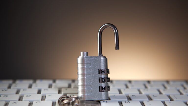 Combination padlock on keyboard representing compliance security
