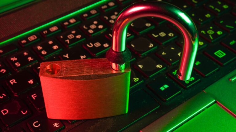 Red padlock on computer keyboard representing cybersecurity